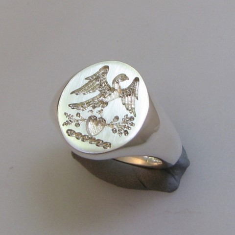 bird on heart crest ring